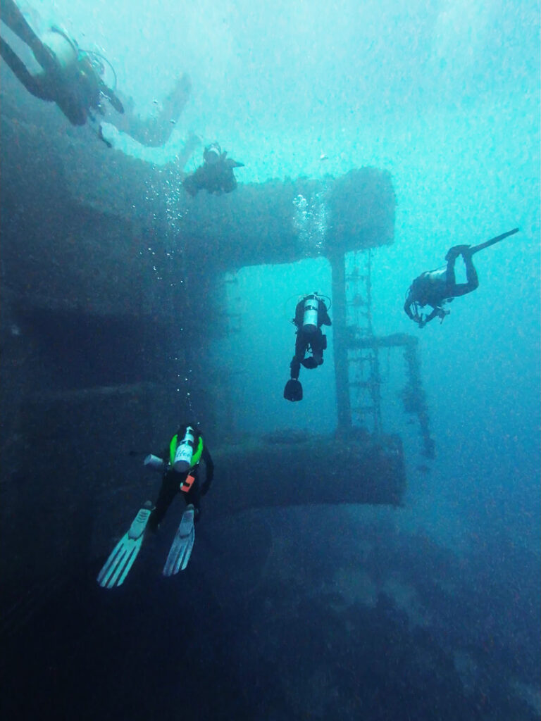 Divers swimming around massive wreck, The Salem Express